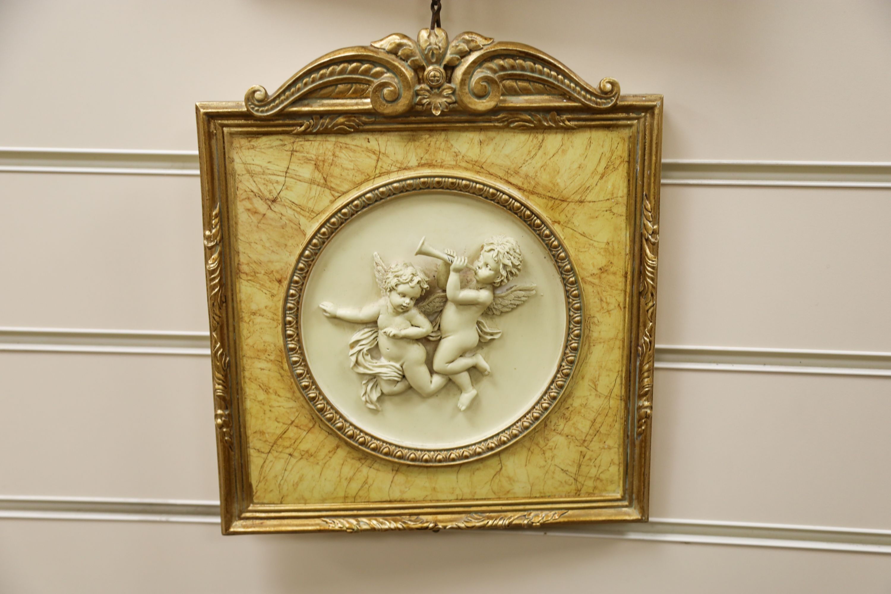 A set of three gilt framed composition plaques 27x23cm